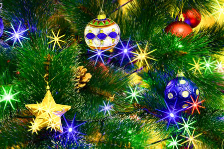 Christmas tree decorated for Christmas and New Year with Christmas tree decorations and LED garland close-up.の写真素材