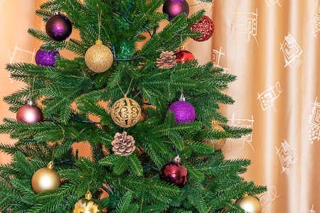 Close-up of a Christmas tree branch decorated with Christmas decorations for the holiday Christmas.の写真素材