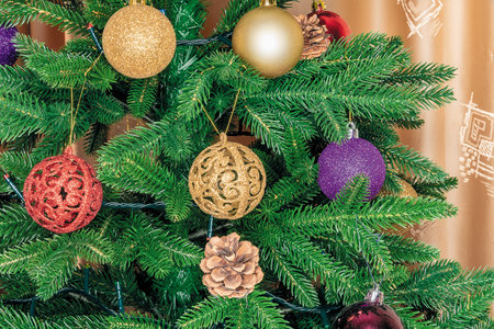 Close-up of a Christmas tree branch decorated with Christmas decorations for the holiday Christmas.の写真素材