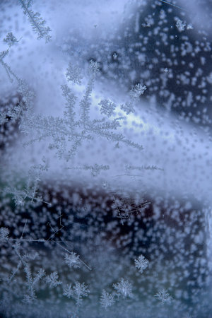 Winter patterns form after severe frosts on the glass.の写真素材