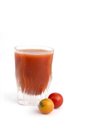 tomato juice  isolated on white  with  two cherry tomatosの写真素材