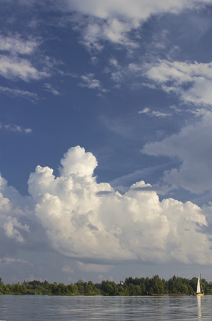 Lanscape on Volga Russia with forest, small sailboat and beautiful skyの写真素材