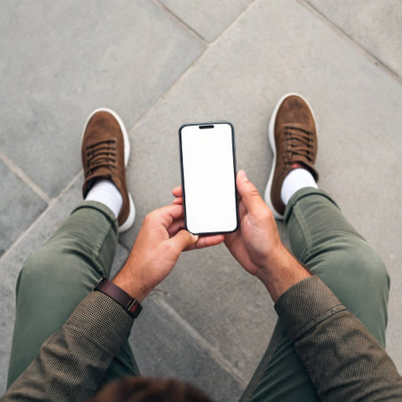 Male hands holding phone top view mockupの素材