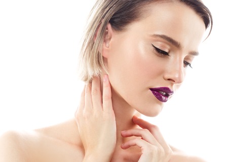 Beauty Woman face Portrait. Beautiful model Girl with Perfect Fresh Clean Skin color lips purple red. Blonde brunette short hair Youth and Skin Care Concept. Isolated on a white backgroundの写真素材
