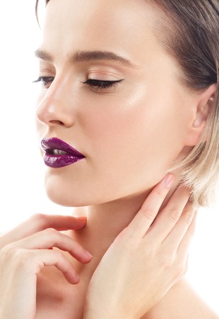 Beauty Woman face Portrait. Beautiful model Girl with Perfect Fresh Clean Skin color lips purple red. Blonde brunette short hair Youth and Skin Care Concept. Isolated on a white backgroundの写真素材