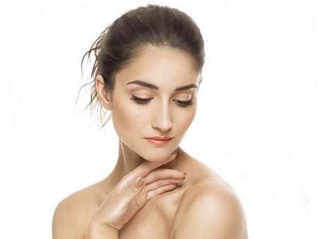 Beauty Woman face Portrait. Beautiful model Girl with Perfect Fresh Clean Skin. Youth and Skin Care Concept. Isolated on a white backgroundの写真素材