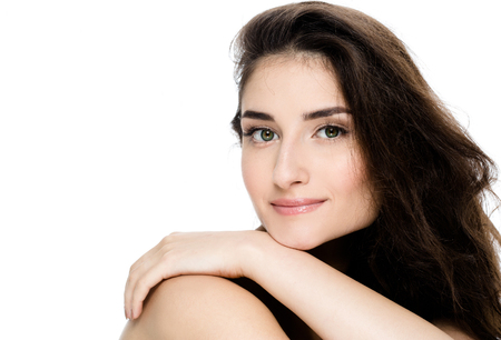 Beauty Spa Woman with perfect face skin Portrait. Beautiful Spa Girl showing empty copy space for text. Proposing a product. Gesture for advertisement. Isolated on whiteの写真素材