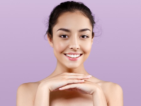 Beautiful woman portrait beauty skin healthy and perfect makeup. Studio shot. PInk background.の写真素材