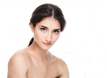 Beautiful Face of Young Woman Model with Clean Fresh Perfect Healthy Skin. Age and Health Concept. Beauty Woman Portrait isolated on whiteの写真素材