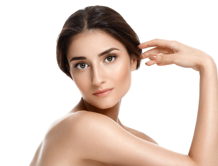 Beauty Spa Woman with perfect face skin Portrait. Beautiful Spa Girl showing empty copy space for text. Proposing a product. Gesture for advertisement. Isolated on whiteの写真素材