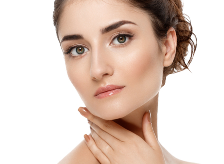 Beautiful woman face close up. Studio shot. Isolated on whiteの写真素材