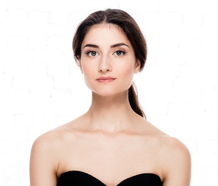 Beautiful woman face close up. Studio shot. Isolated on white.の写真素材