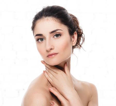 Beauty Woman face Portrait. Beautiful model Girl with Perfect Fresh Clean Skin. Youth and Skin Care Concept. Isolated on a white backgroundの写真素材