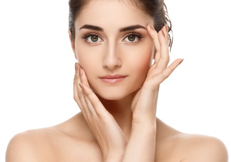 Beautiful woman face close up. Studio shot. Isolated on whiteの写真素材