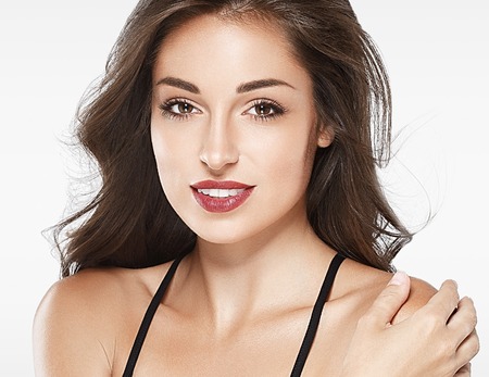 Beautiful woman red lips fly hair portrait healthy skinの写真素材