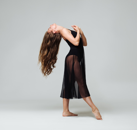Woman in dance studio beautiful. Studio shot. Gray background.の写真素材