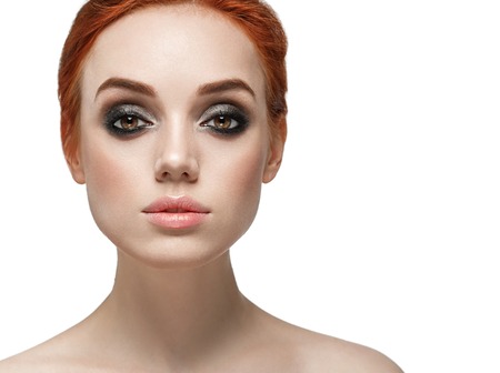 Beautiful woman face close up. Smoky black make up on eyes. Beautiful portrait isolated on whiteの写真素材