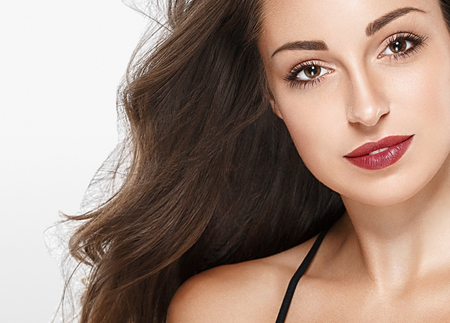 Beautiful woman red lips fly hair portrait healthy skinの写真素材