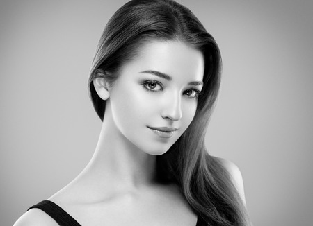 Beautiful woman face close up portrait young studio black and whiteの写真素材