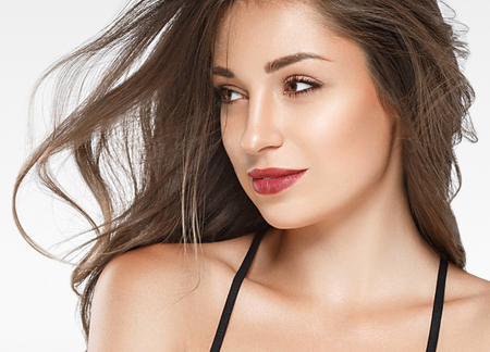 Beautiful woman red lips fly hair portrait healthy skinの写真素材