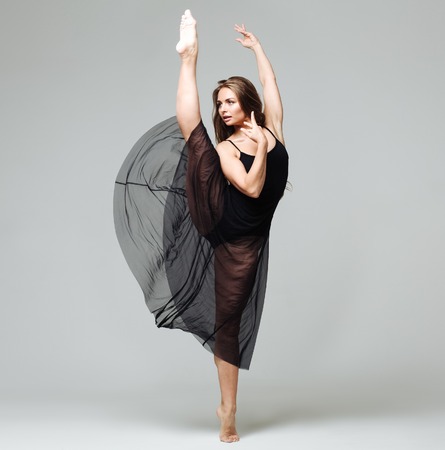 Woman in dance studio beautiful. Studio shot. Gray background.の写真素材