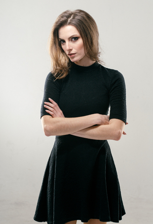 Portrait of beautiful young curly hair woman girl in black dress. Fashion photoの写真素材