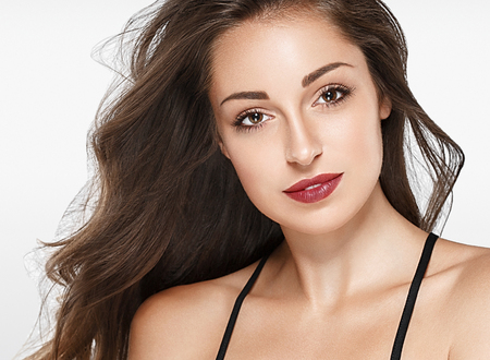 Beautiful woman red lips fly hair portrait healthy skinの写真素材