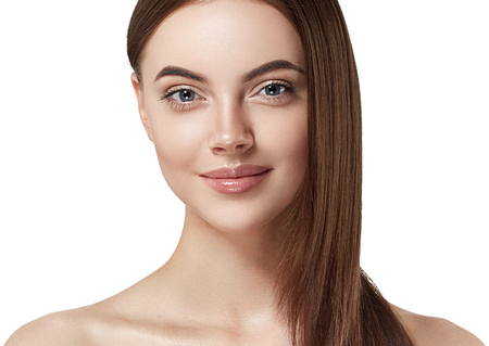 Beautiful woman face close up portrait long beautiful hair young. Studio shot. Isolated on white.の写真素材