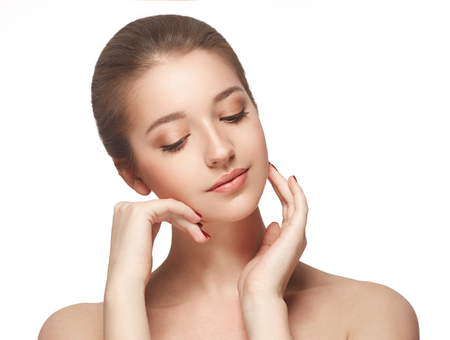 Beautiful woman face close up portrait young. Studio shot. Isolated on white.の写真素材