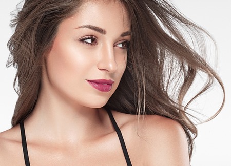 Beautiful woman red lips fly hair portrait healthy skinの写真素材