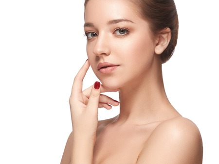 Beautiful woman face close up portrait young. Studio shot. Isolated on white.の写真素材