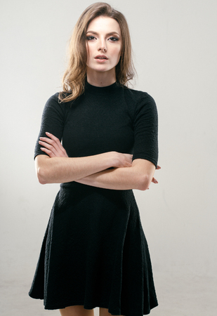 Portrait of beautiful young curly hair woman girl in black dress. Fashion photoの写真素材