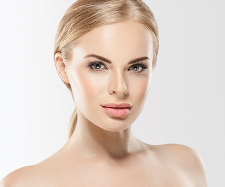 Beautiful woman blonde hair face close up portrait studio on whiteの写真素材