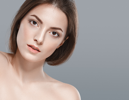 Beautiful woman portrait face studio isolated on gray. Studio shot.の写真素材
