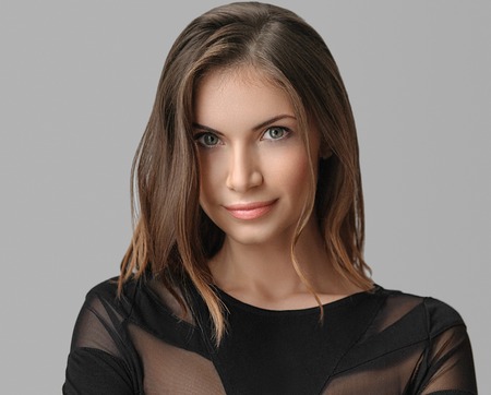 portrait of a beautiful young woman with perfect skin and beautiful hair closeup. Studio shot.の写真素材
