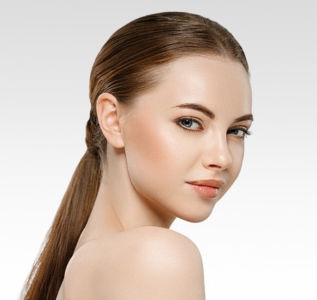 Woman beauty face portrait isolated on white with healthy skin. Studio shot.の写真素材