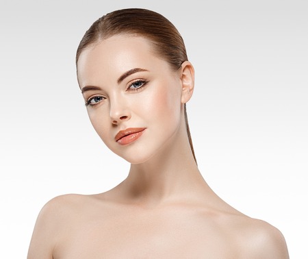 Woman beauty face portrait isolated on white with healthy skin. Studio shot.の写真素材