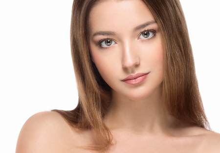 Beautiful woman face close up portrait young. Studio shot. Isolated on white.の写真素材