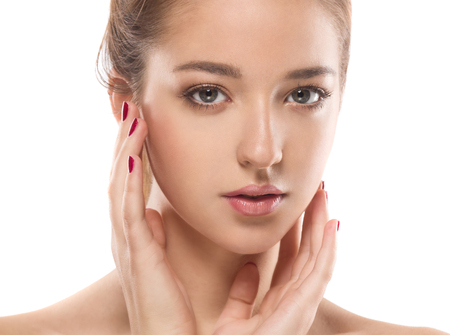 Beautiful woman face close up portrait young. Isolated on white. Studio shot.の写真素材
