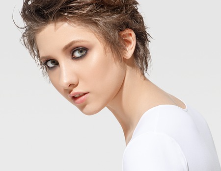 Beauty Woman face Portrait. Beautiful model Girl with Perfect Fresh Clean Skin. Youth and Skin Care Concept. Isolated on a white backgroundの写真素材