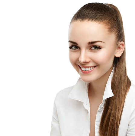 Happy smiling businesswoman with hair tail, isolated on white background. Studio shot.の写真素材