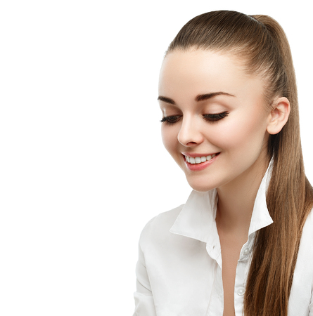 Happy smiling businesswoman with hair tail, isolated on white background. Studio shot.の写真素材