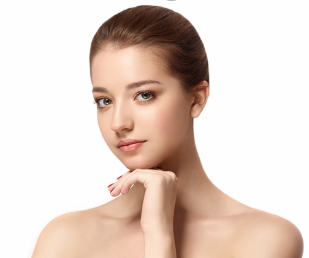 Beautiful woman face close up portrait young. Studio shot. Isolated on white.の写真素材