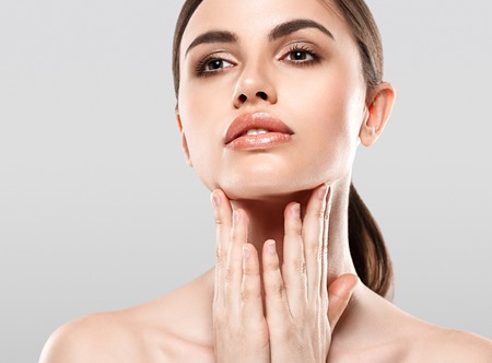 Woman Beauty portrait of attractive female. Skin care, cosmetics and makeup concept.Isolated on gray. Healthy perfect skin.の写真素材