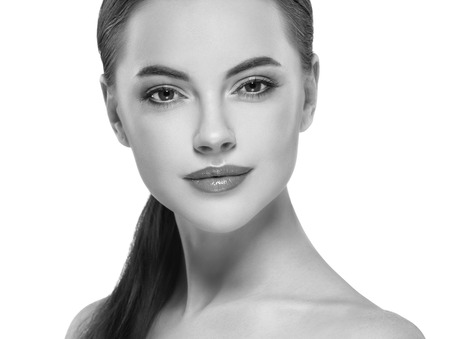 Beauty Woman face Portrait. Black and white. Beautiful model Girl with Perfect Fresh Clean Skin. Youth and Skin Care Concept.の写真素材