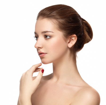 Beautiful woman face close up portrait young. Studio shot. Isolated on white.の写真素材