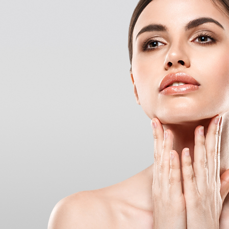 Woman Beauty portrait of attractive female. Skin care, cosmetics and makeup concept.Isolated on gray. Healthy perfect skin.の写真素材
