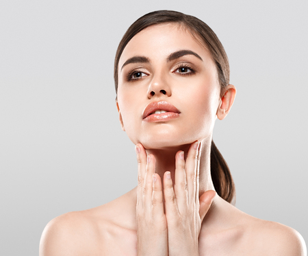 Woman Beauty portrait of attractive female. Skin care, cosmetics and makeup concept.Isolated on gray. Healthy perfect skin.の写真素材
