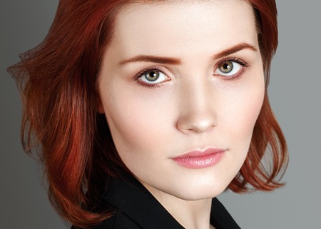 Fashion Beautiful red hair woman portrait. Close up view. Studio shot.の写真素材