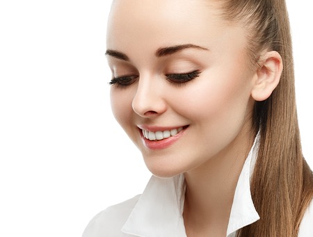 Happy smiling businesswoman with hair tail, isolated on white background. Studio shot.の写真素材